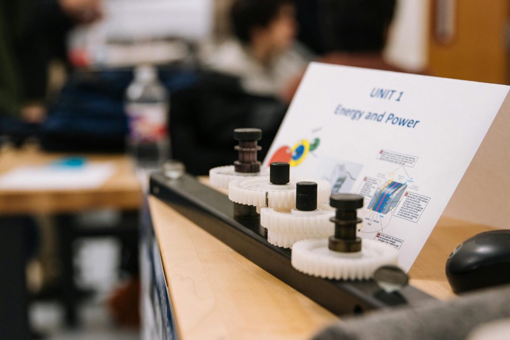 Close-up of gears demonstrating energy and power concepts in an educational setting.